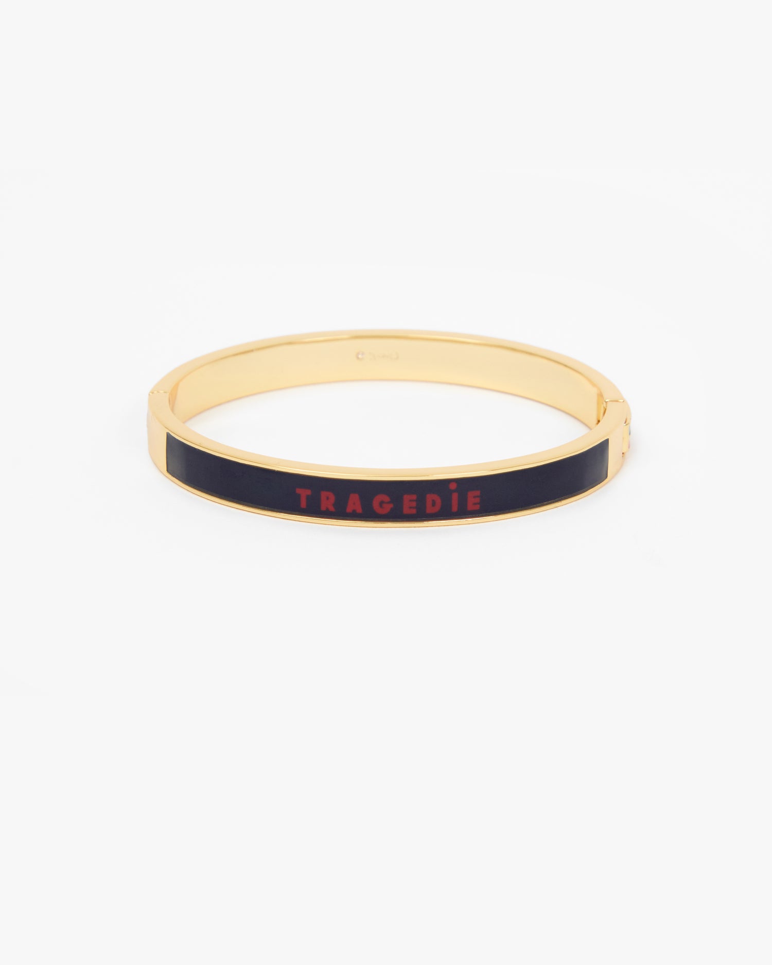 Le Bangle Bracelet featuring a black enamel inlay with the word 'TRAGEDIE' in red lettering.