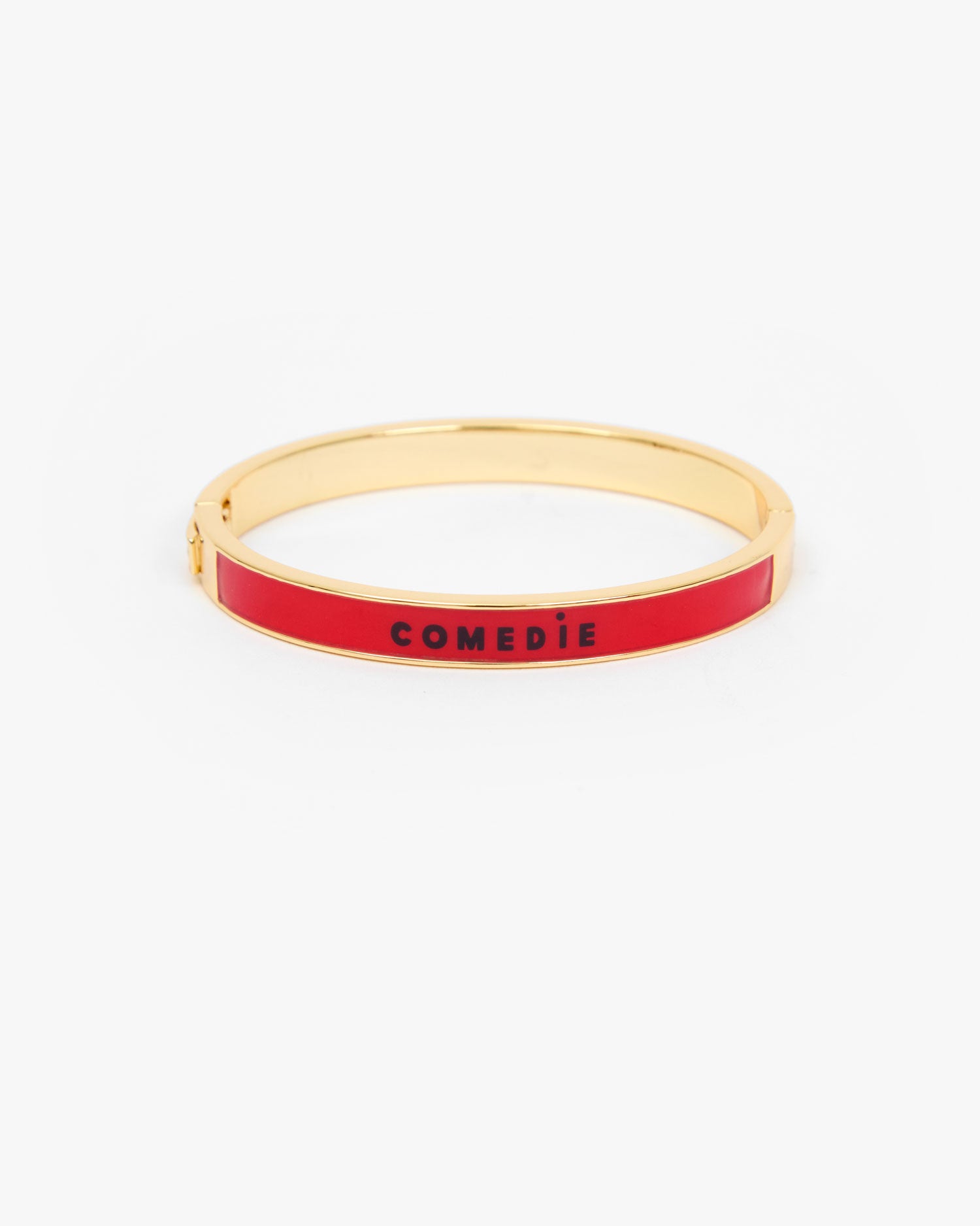 Le Bangle Bracelet with a vibrant red enamel inlay and the word 'COMEDIE' printed in black on the front.