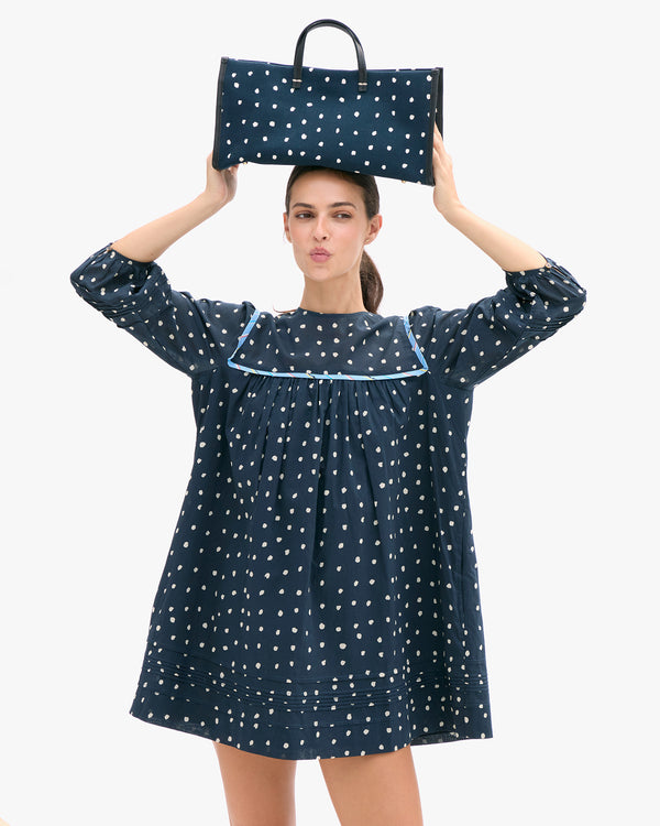 Model wearing the CV x Ciao Lucia Dress and matching Sam tote bag. 
