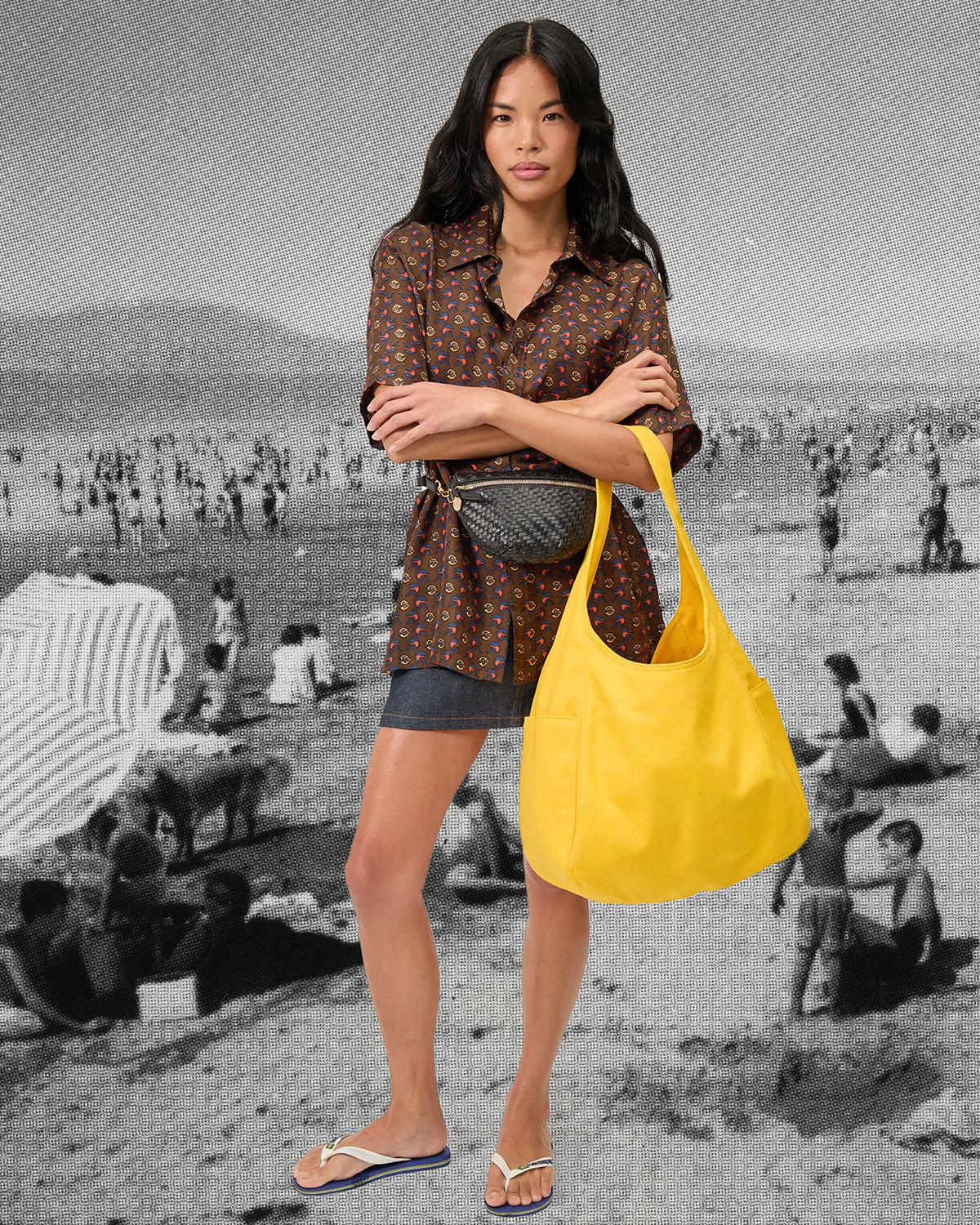 Model carrying the Snapdragon Canvas Grand Bateau and wearing the Petite Fanny in Black Zig Zag around her waist. 