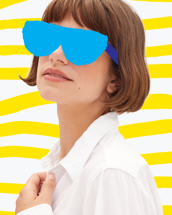 Model with hand-drawn blue sunglasses over her eyes. 