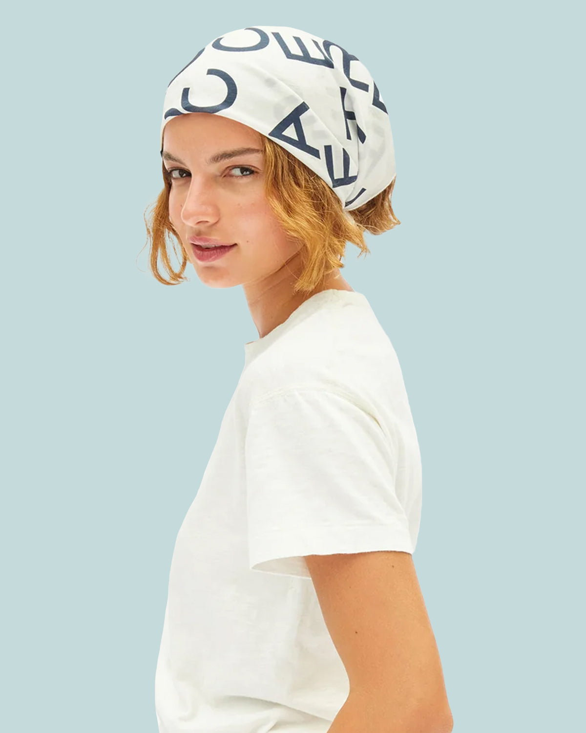 Model wearing the Cream with  Navy Le Text Bandana as a head wrap. 